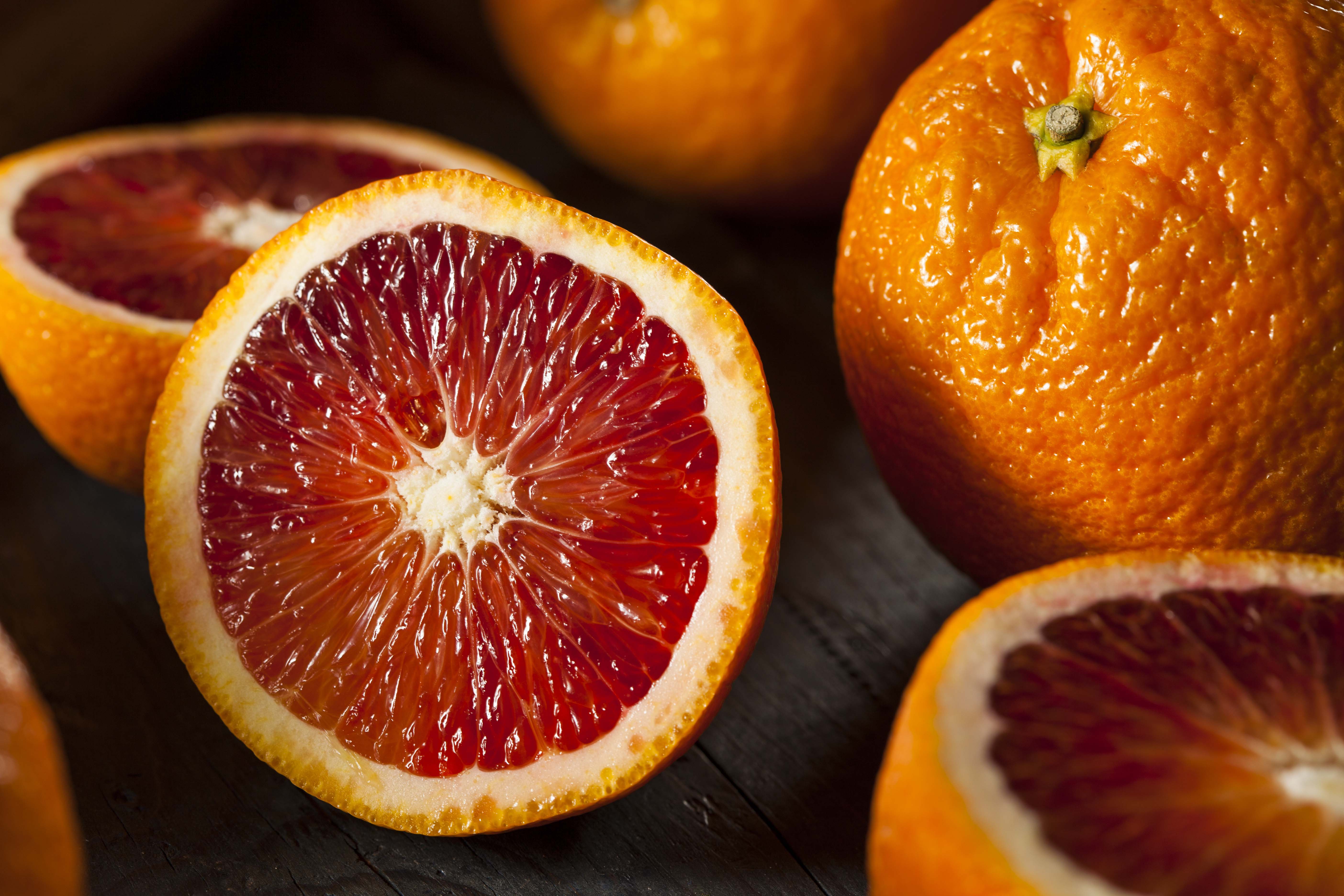 Whole and cut blood oranges
