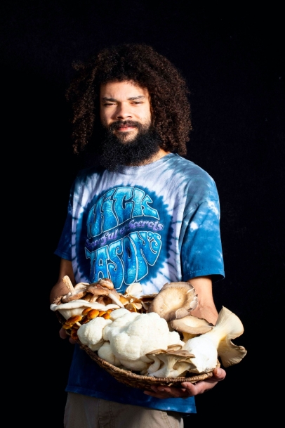 mike holding basket of mushrooms from Southwest Mushrooms