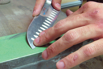 close up of knife, sharpening