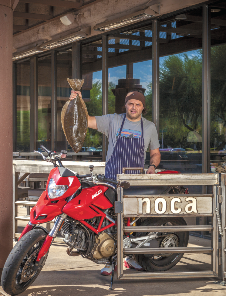 Chef Claudio Urciuoli holding a fish