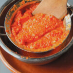 Romesco sauce in a sieve