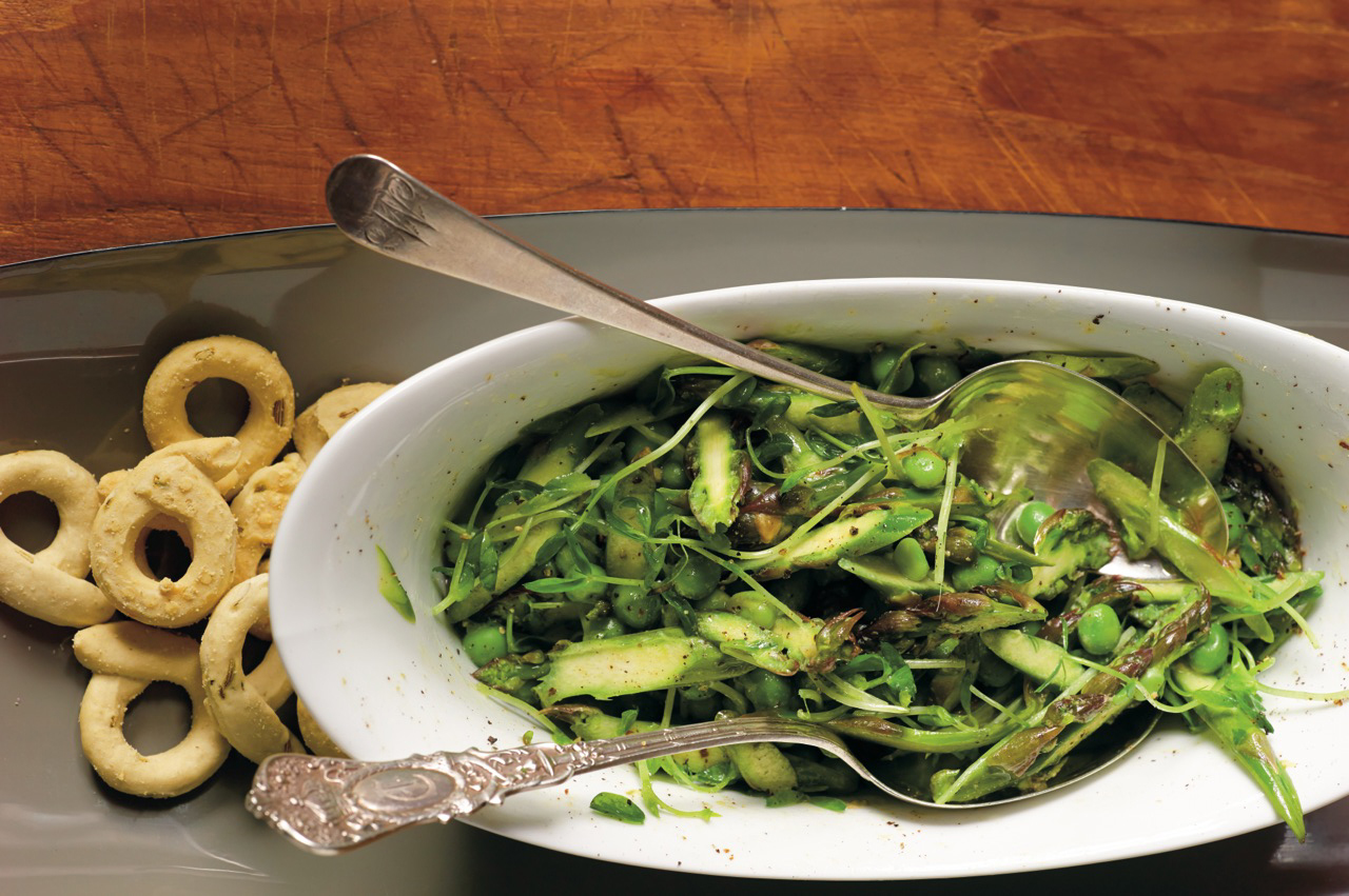 Bowl of asparagus salad with tongs